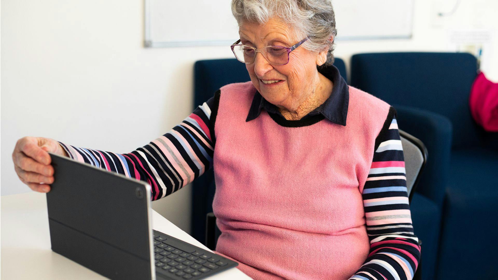 An older woman using the Gateway website on a laptop
